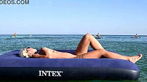 Isn't this tattooed blonde bitch's big boobs stunning on nude beach?