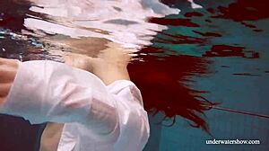 Lola's Big Natural Tits Bounce as Redhead Swims Underwater in Tight Pool