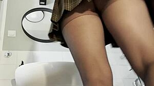 hot blonde babe strips pantyhose miniskirt high heels big tits ass bathroom tease