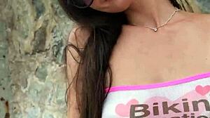 sexy petite brunette babe flashes bikini at public beach photoshoot