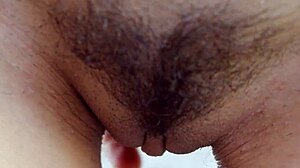 The sexiest brunette fitness babe spreads her hairy pussy up close outdoors