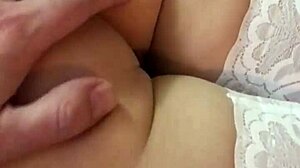 Brunette amateur shows naked ass legs feet in bed wearing white stockings close-up