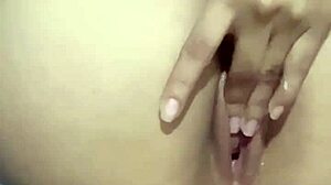 a young beauty gently plays with her tight pussy
