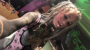 tattooed alternative girl plays with her toy