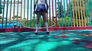 Young latina shows panties under skirt while walking in the park