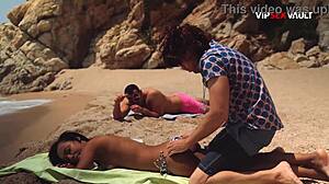 two guys oil down a fit black babe on the beach she loves it